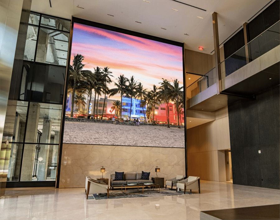 A video wall digital display high on a wall in a commercial building lobby