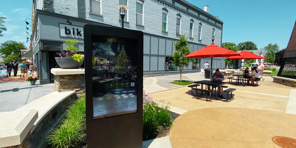 A brown outdoor digital kiosk during the daytime in a city plaza in Ludington, Michigan.