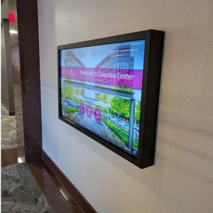 touchsource-black-crestone-55-inch-horizontal-touchscreen-directory - TouchSource - TouchSource Wall-mounted digital display in a hallway showing a 'Welcome to Columbia Center' banner with building photos and greenery in the background.