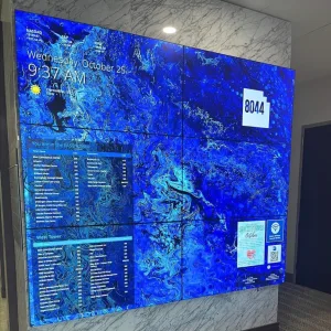 touchsource-digital-art-6-screen-static-video-wall-directory - TouchSource - TouchSource Lobby screen wall showing a blue marbled display with time 9:37 AM and date Wednesday, October 25; a large '8044' label is visible.